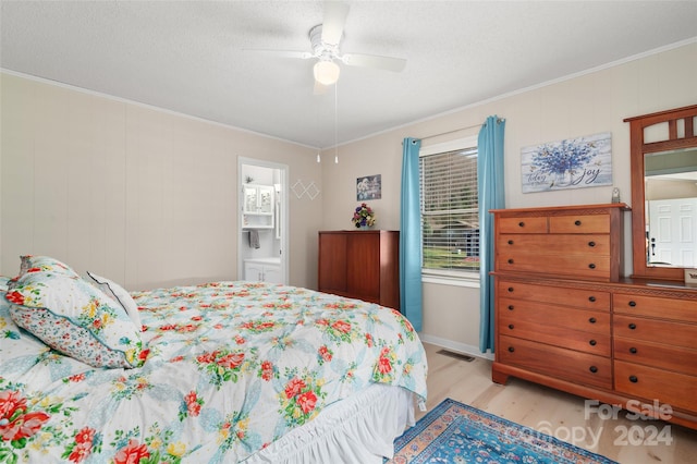 bedroom with connected bathroom, light hardwood / wood-style flooring, ceiling fan, and crown molding