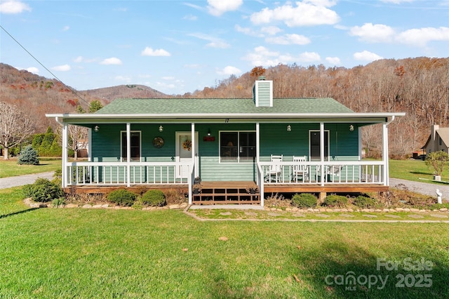 17 Dream Meadow Ln, Maggie Valley, NC 28751 - farmhouse-style home with a chimney, a front lawn, roof with shingles, and a porch