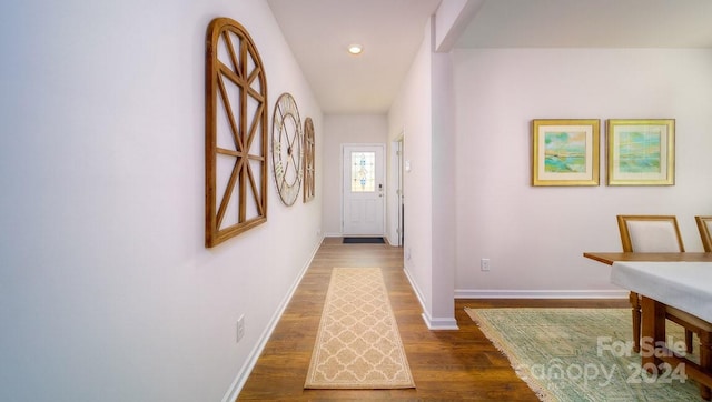 hallway with dark hardwood / wood-style flooring