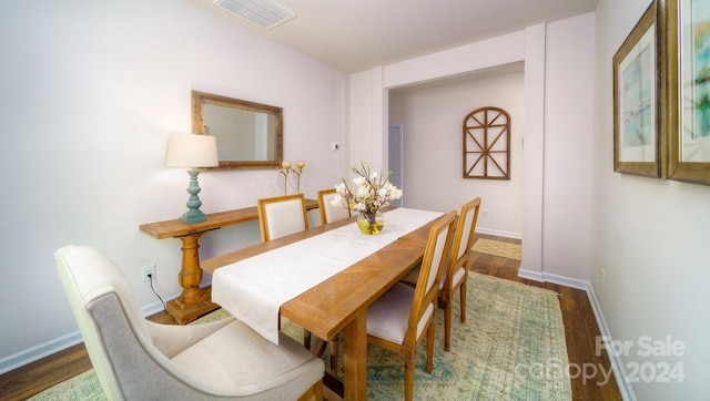 dining space with dark hardwood / wood-style floors