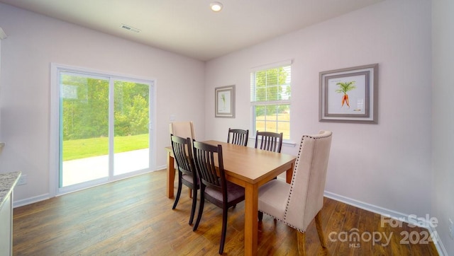 dining area with dark hardwood / wood-style flooring