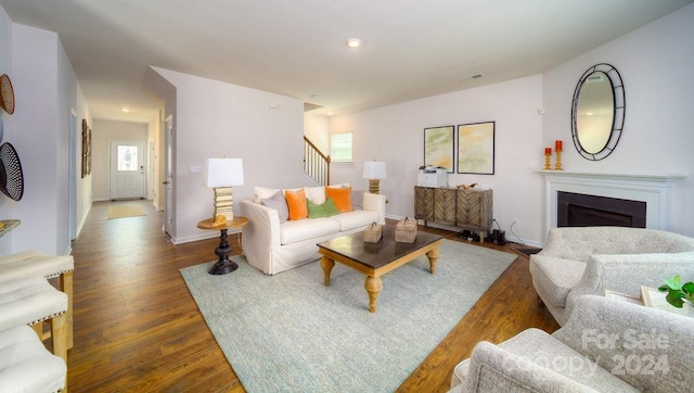 living room with dark hardwood / wood-style flooring and plenty of natural light