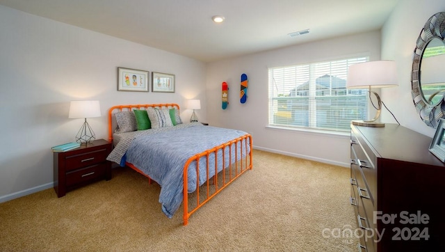 bedroom featuring light colored carpet