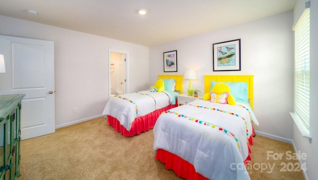 carpeted bedroom with ensuite bath