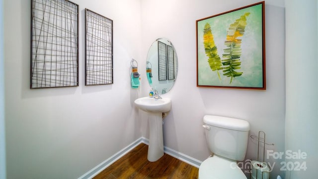 bathroom featuring hardwood / wood-style floors and toilet