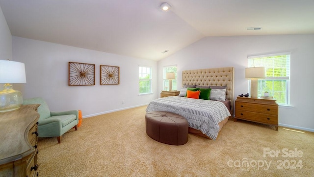 bedroom with light carpet and lofted ceiling