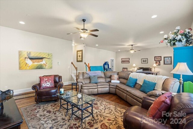 living room featuring ceiling fan and wood-type flooring