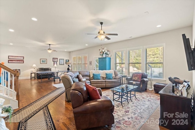 living room with wood-type flooring and ceiling fan