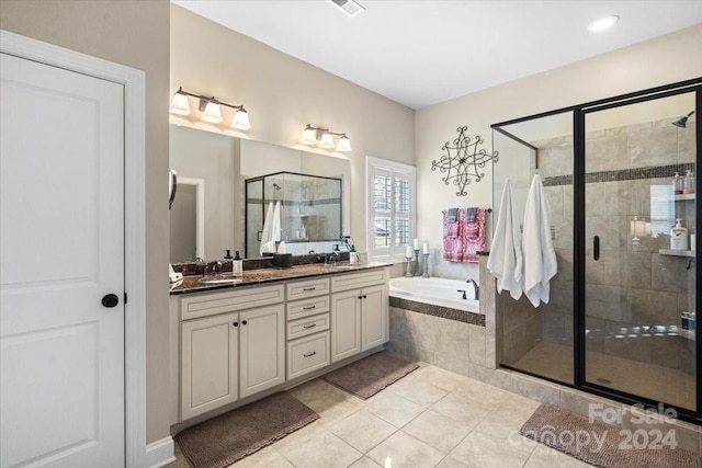 bathroom featuring tile patterned flooring, vanity, and plus walk in shower