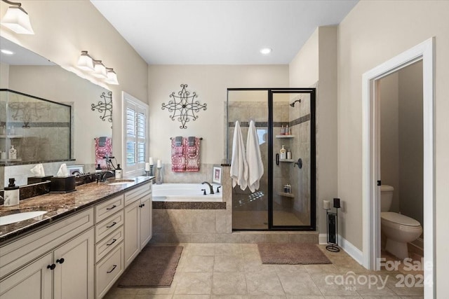 full bathroom featuring tile patterned flooring, vanity, toilet, and independent shower and bath