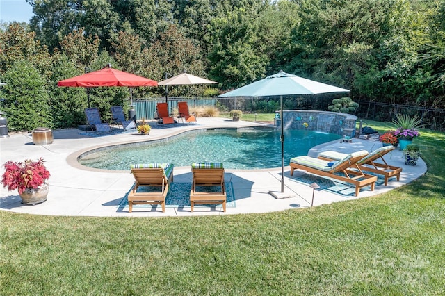 view of pool featuring a yard, pool water feature, and a patio area