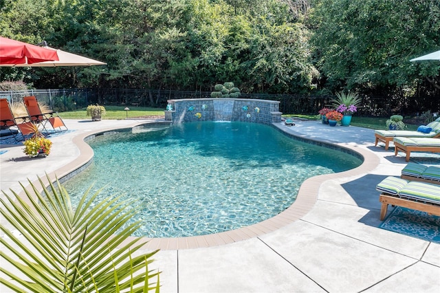 view of swimming pool featuring pool water feature and a patio area