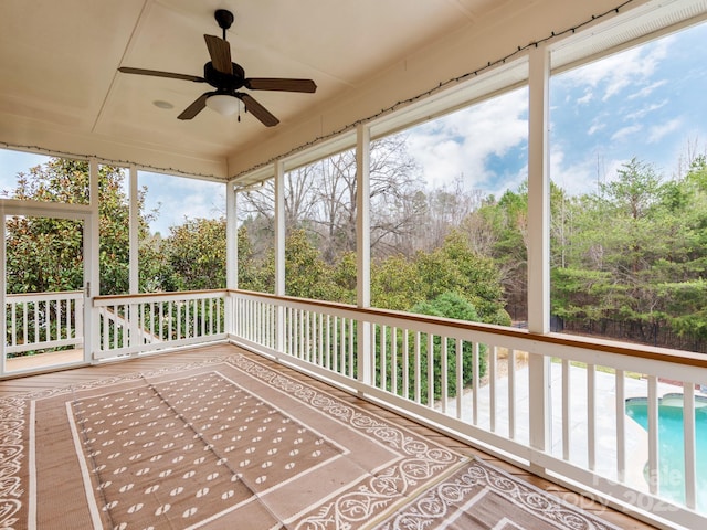 unfurnished sunroom featuring a ceiling fan