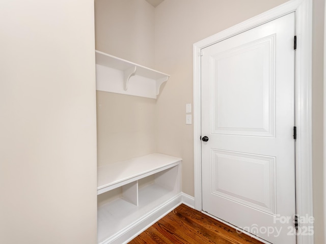 mudroom with dark wood-type flooring and baseboards