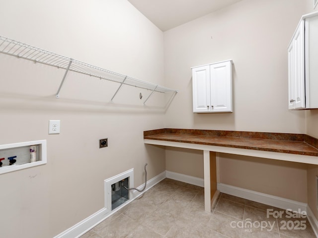 washroom with cabinet space, washer hookup, baseboards, and electric dryer hookup