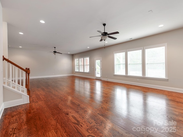 unfurnished living room featuring recessed lighting, dark wood finished floors, stairway, ceiling fan, and baseboards