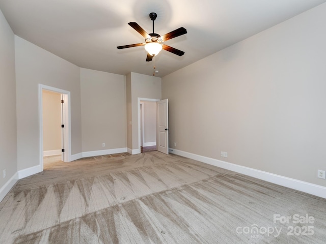 unfurnished bedroom featuring baseboards, a ceiling fan, and light colored carpet