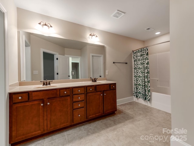 full bathroom featuring shower / bath combo, double vanity, a sink, and visible vents