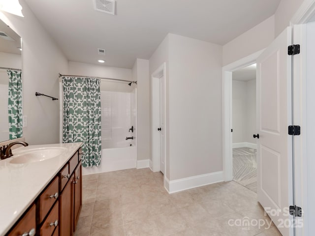 full bath featuring visible vents, shower / bath combo, baseboards, and vanity