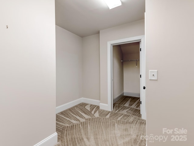 interior space with light carpet and baseboards