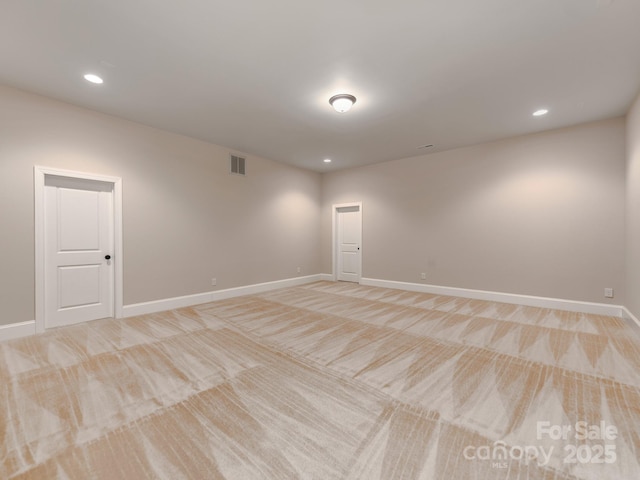 spare room with visible vents, baseboards, light colored carpet, and recessed lighting