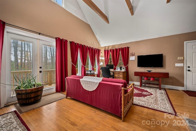 living room with hardwood / wood-style floors, beam ceiling, high vaulted ceiling, and french doors