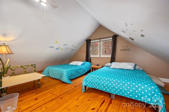 bedroom with ceiling fan, hardwood / wood-style floors, and lofted ceiling