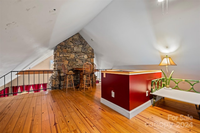 interior space featuring wood-type flooring and lofted ceiling