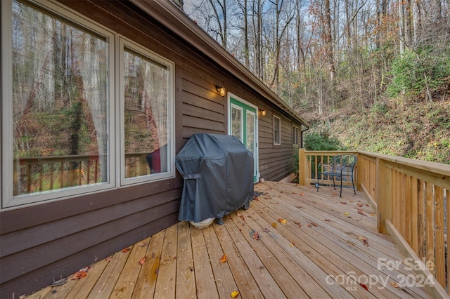 wooden deck with a grill