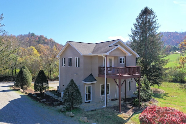 view of front facade featuring a patio and a deck