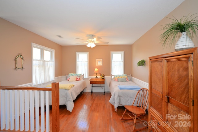 bedroom with ceiling fan and light hardwood / wood-style flooring