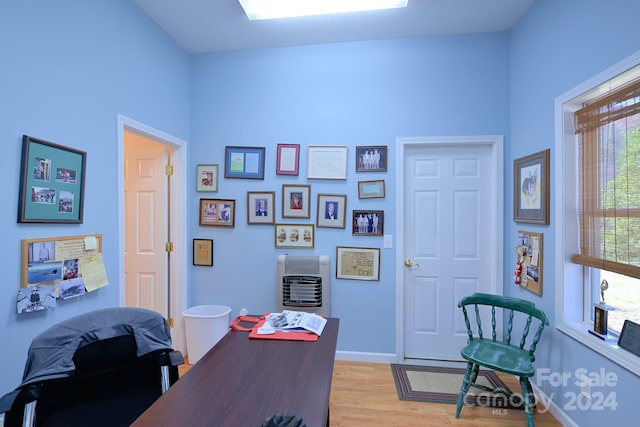 office area featuring heating unit and light hardwood / wood-style flooring