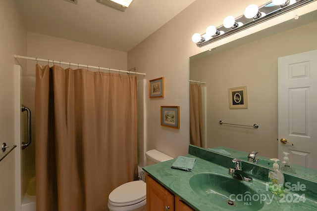 bathroom with walk in shower, vanity, and toilet