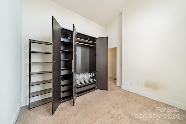 unfurnished bedroom featuring light carpet