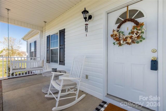 entrance to property featuring a porch