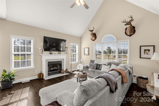 living room featuring ceiling fan, high vaulted ceiling, a healthy amount of sunlight, and dark hardwood / wood-style floors