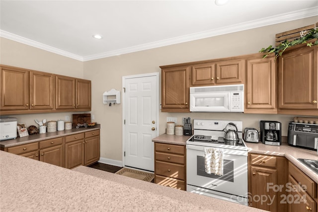 kitchen with white appliances and ornamental molding