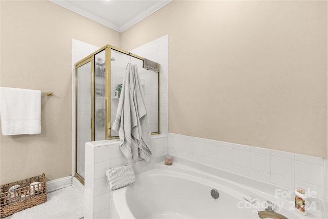 bathroom featuring ornamental molding and shower with separate bathtub