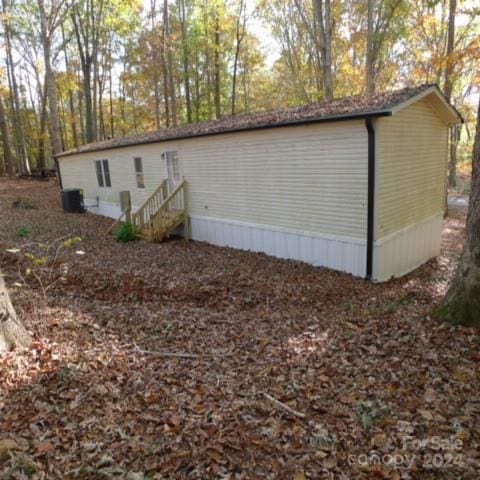 view of side of home featuring central AC