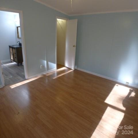 unfurnished room with dark hardwood / wood-style flooring and ornamental molding