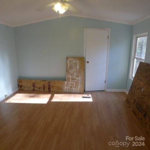 interior space with hardwood / wood-style floors, vaulted ceiling, and ceiling fan