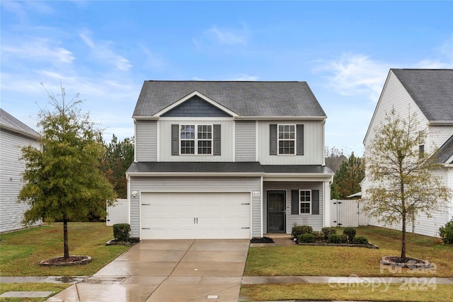 view of front facade with a front yard and a garage