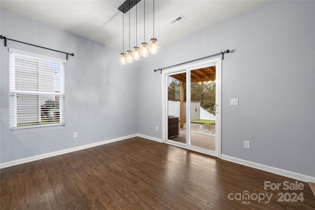 unfurnished room with dark hardwood / wood-style floors