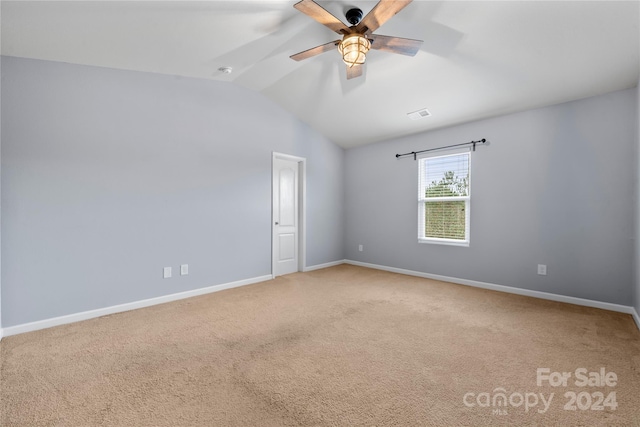 empty room featuring carpet flooring, ceiling fan, and lofted ceiling