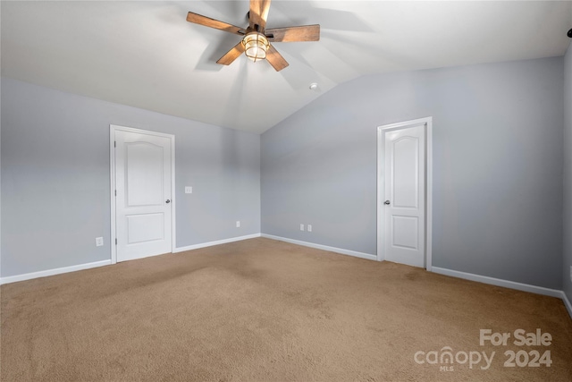 empty room featuring carpet floors, ceiling fan, and lofted ceiling