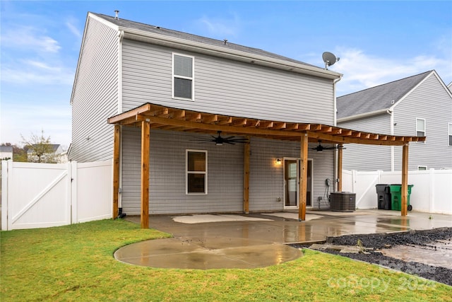 rear view of property featuring a lawn, a patio area, ceiling fan, and central air condition unit