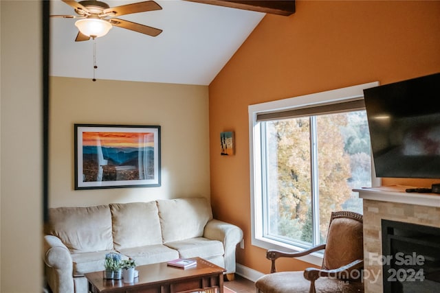 living room featuring ceiling fan and lofted ceiling with beams