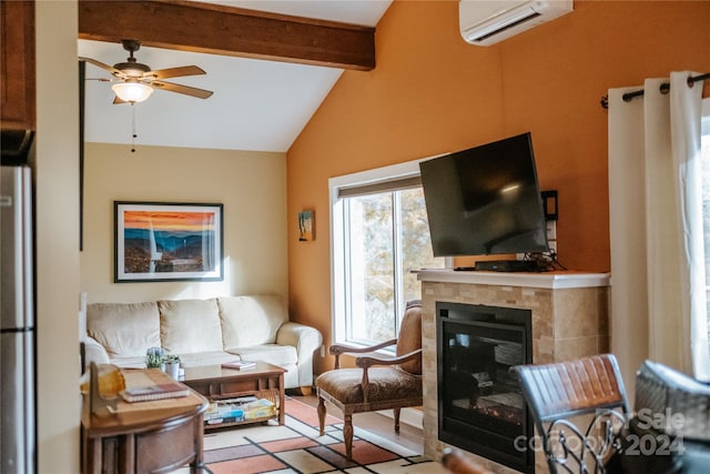 living room with vaulted ceiling with beams, ceiling fan, an AC wall unit, and a tile fireplace