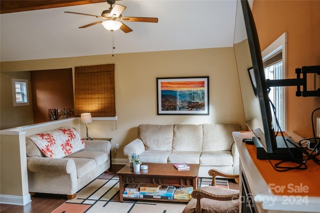 living room with ceiling fan and dark wood-type flooring