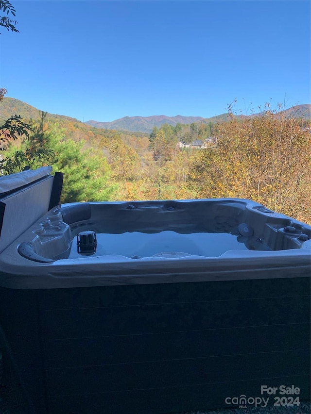 view of yard with a mountain view and a hot tub